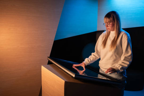 istock Adolescent girl using touch screen display on museum exhibition 2130299083