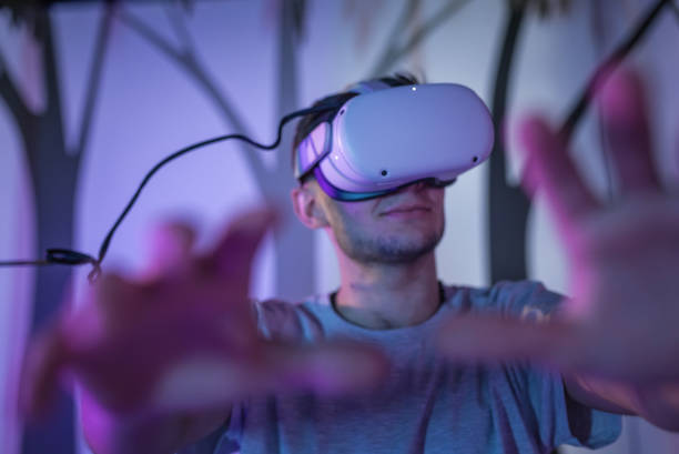 istock Young man with a VR headset, a simulation of being in the forest 2130300137