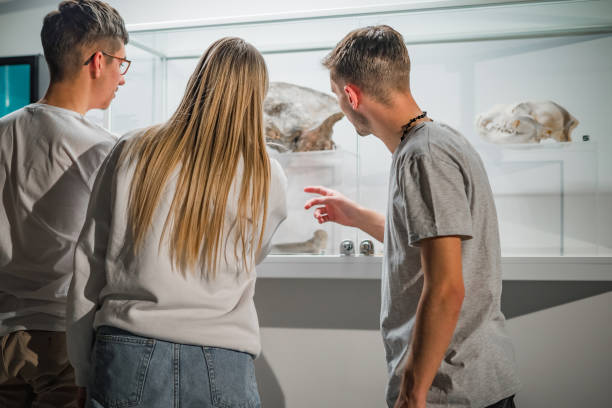istock Boy as a curator, explaining museum artifacts to his friends 2130309126