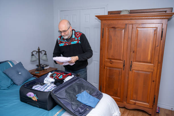 istock Mature man placing shirt 2130323504