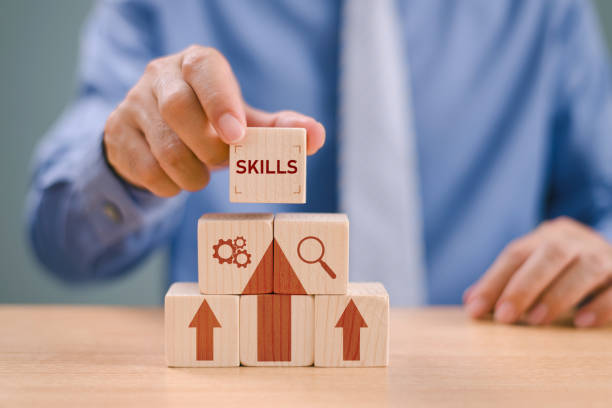 skill development concept. up new ability skill for technology evolution. employee thinking, digital upskill. businessman hand hold wooden cube with digital skill icon on white background, copy space - melhoria de competências imagens e fotografias de stock