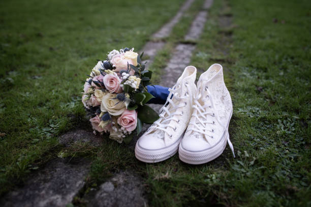 Bride's Wedding Plimsoles and Bouquet on Grass