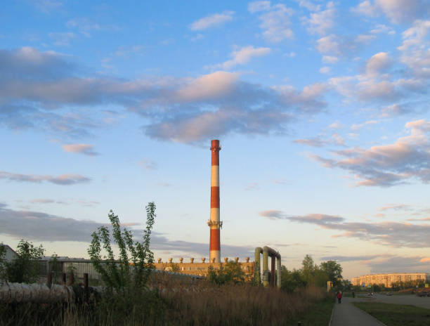 istock Boiler room pipe in sunlight against the sky in the evening 2130348799