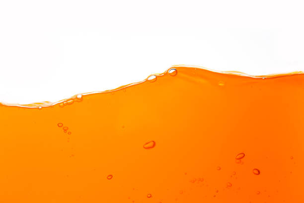 istock orange juice texture isolated white background,Close up bright orange juice texture for health and nature waves 2130356257