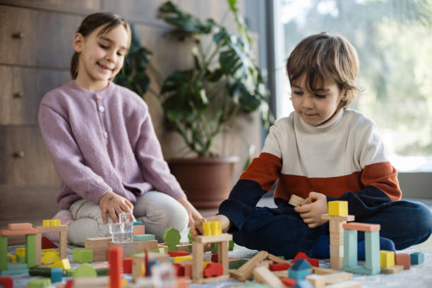 istock children playing with toy blocks at home together 2130374036