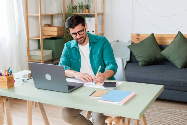 istock Man working comfortably from home office 2130383398