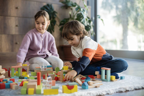 istock children playing with toy blocks at home together 2130385570
