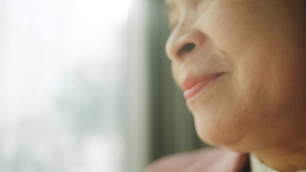 istock Mature woman applying lipstick. 2130389728