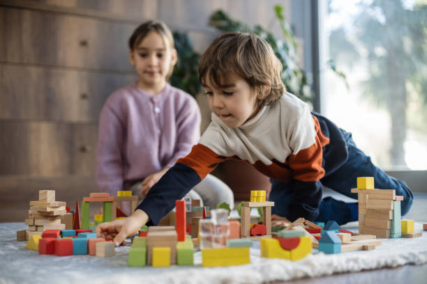 istock children playing with toy blocks at home together 2130404779