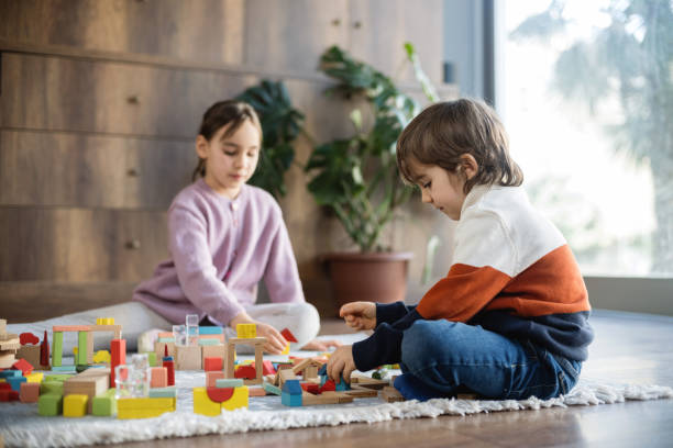 istock children playing with toy blocks at home together 2130412497