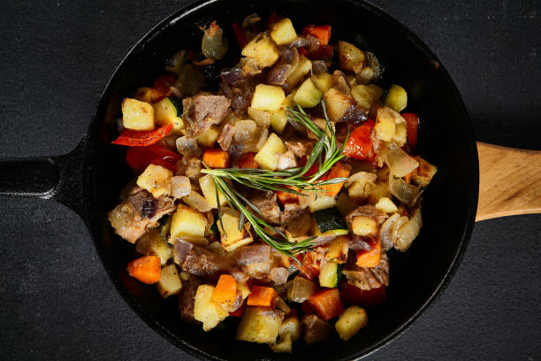 istock Top view of a hearty skillet beef ragout with mixed vegetables on a textured black backdrop 2130467056