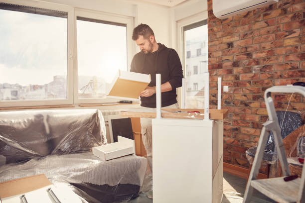 istock Man working and assembling furniture in a new apartment. 2130512970