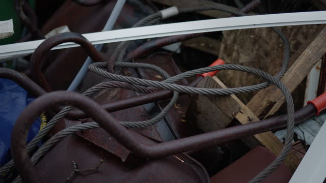 Iron rope and rusty wheelbarrow, handheld