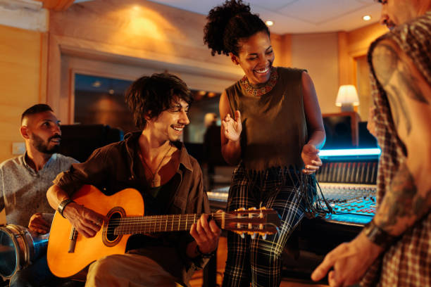 istock Friends playing instrument and having fun in the music studio 2130554274