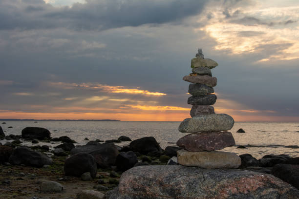 Stacked stones on a beach on the Baltic Sea coast at sunset