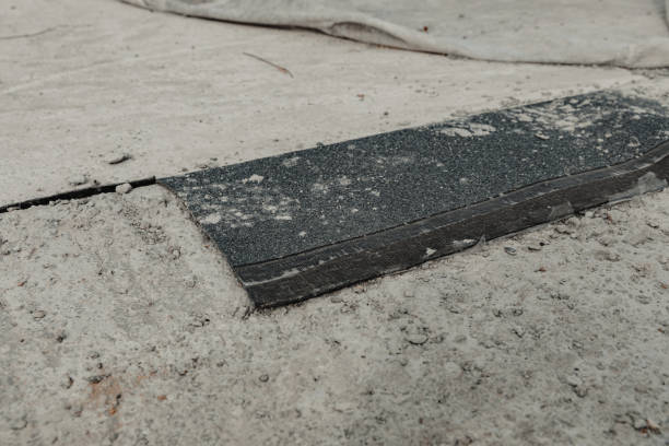 istock a cell phone sits on the ground beside a patch of cement 2130620475