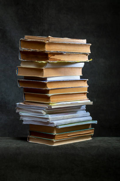 istock A stack of old books and notebooks on the table 2130623062