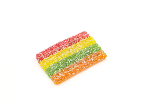 Rainbow stripes sugar crystals sprinkled gummy jelly candy isolated on white background