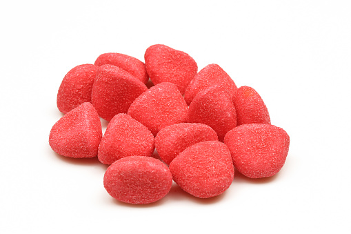 Pile of red gummy candies treat isolated on white background