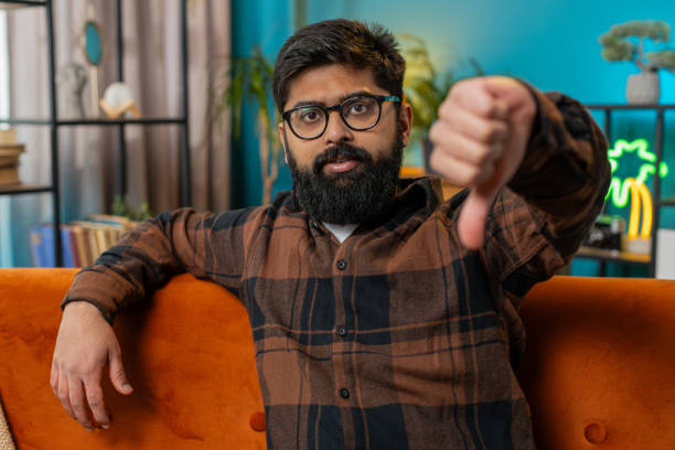 istock Upset Arabian man showing thumbs down, dislike bad work, disapproval dissatisfied feedback at home 2130633400