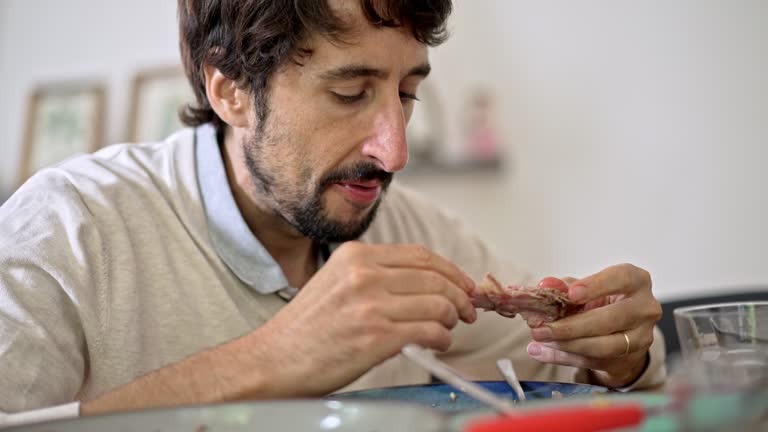 Chewing Begins As Man Grabs Lamb Rib Piece With Hands