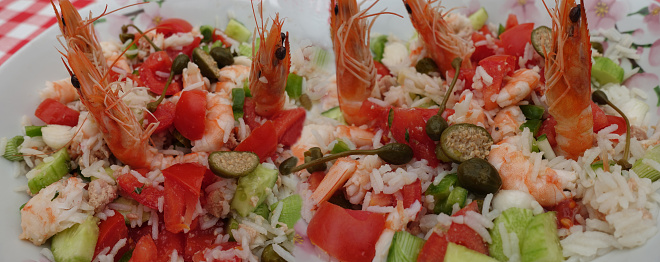 Rice salad with raw vegetables and shrimps  Appetizer buffet