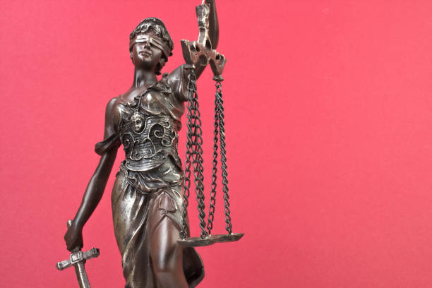 Law concept - Open law book with a wooden judges gavel on table in a courtroom or law enforcement office on blue background. Copy space for text