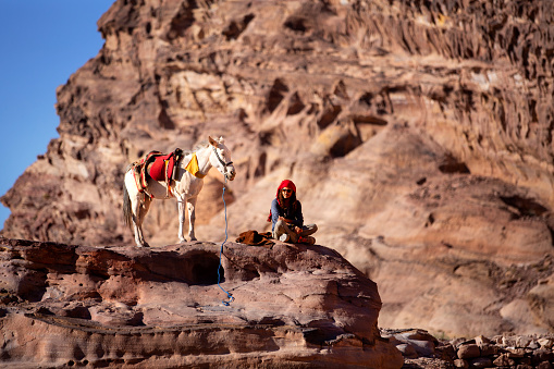 Petra, Jordan - November 3, 2022: Bedouin man and donkey in the ancient city, UNESCO World Heritage Site