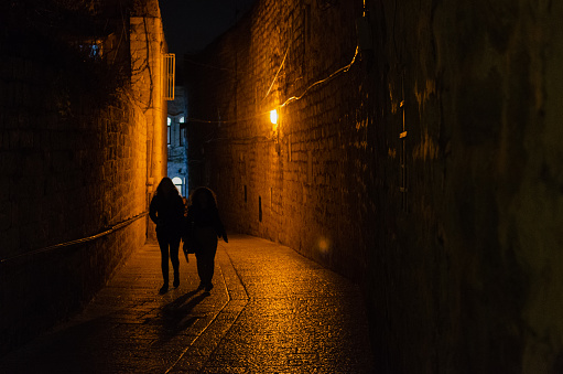 Jerusalem, Israel — December 19, 2019: Night walk inside Jerusalem's ancient walls at night, immersed in city lights.