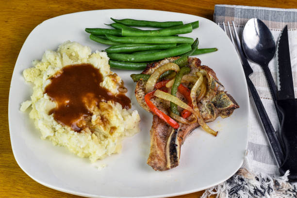 istock pork chop with mash potatoes and green beans 2130705543