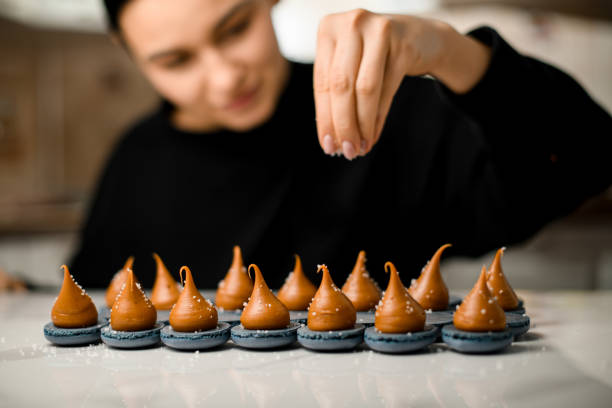 istock Focus on macaroons with cream spread sprinkled with coconut shavings 2130709177