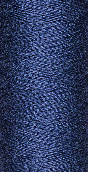 macro texture of a skein of blue sewing thread close-up