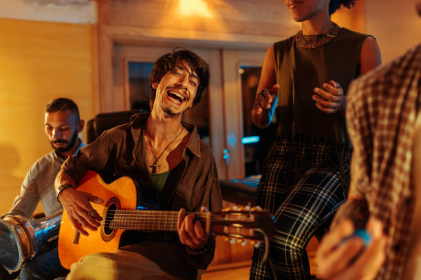istock Musician friends singing and playing instruments in the music studio 2130799505
