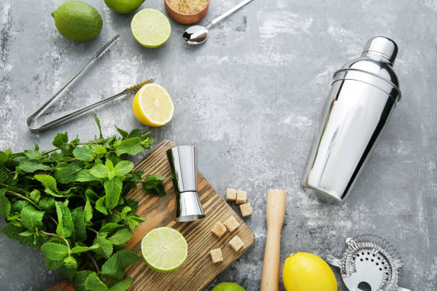 istock Barman equipments with limes, lemons and mint leafs on grey wooden table 2130803137