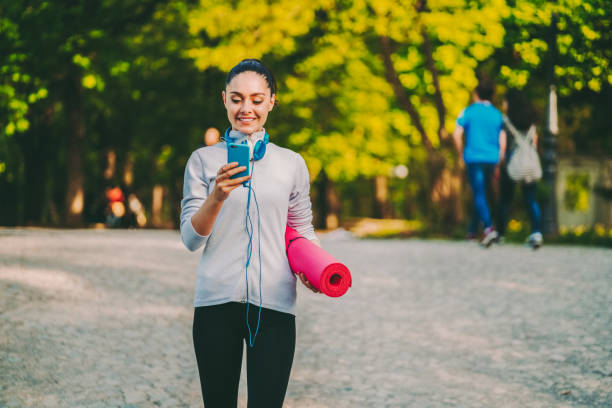 istock Sportswoman in the park texting on smartphone 2130817178