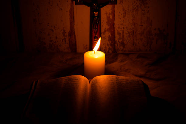 Holy bible, crucifix and candle