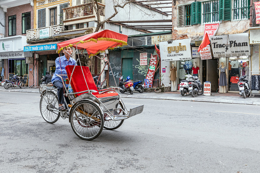 Man driving Electric rickshaw on the road