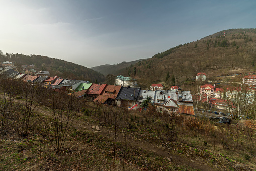 Spa town from green forest over valey with streets of Jachymov CZ 03 30 2024