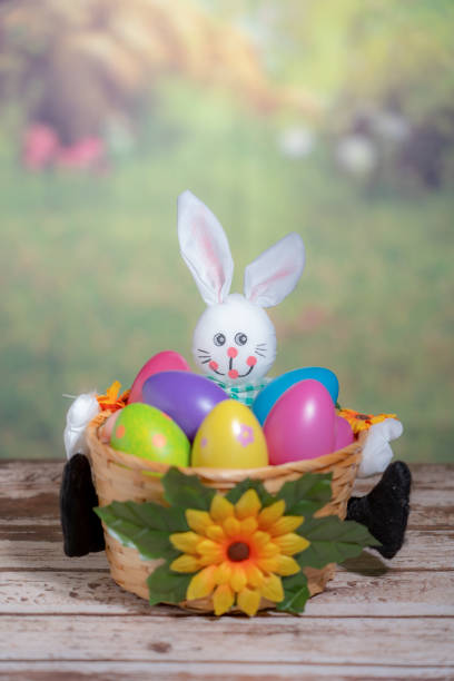 A statue of a rabbit holding colored Easter eggs. Easter, Pascha or Resurrection Sunday concept