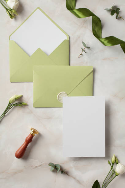 istock Flat lay composition with wedding invitation card mockup and envelopes on stone background. Flat lay, top view, copy space 2130884250