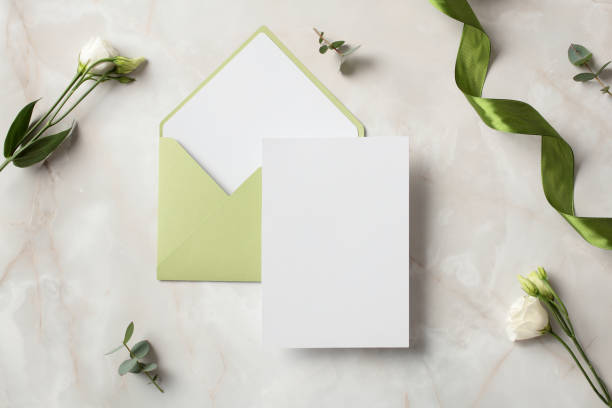 istock Wedding invitation card mockup with olive envelope on stone table top view. 2130886760
