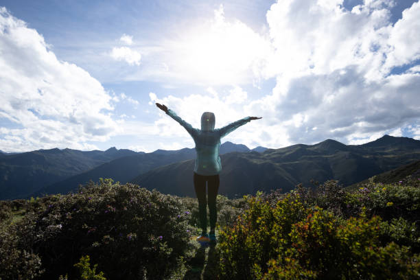 istock Successful woman outstretched limbs at high altitude mountain peak 2130886821