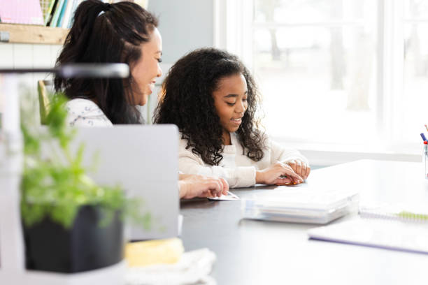 istock Mother and daughter work on project together 2130892681