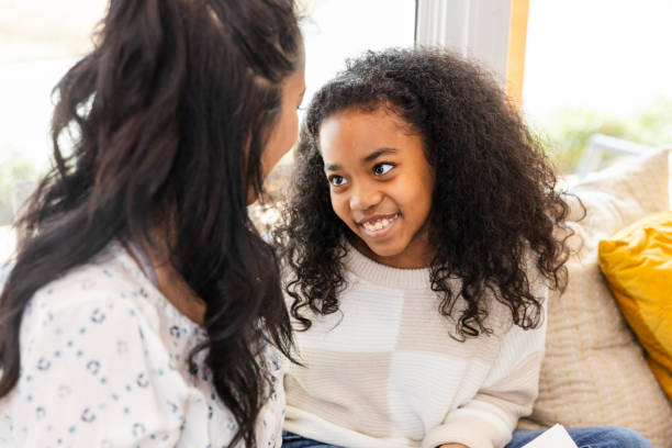 istock Elementary age girl smiles at something her mom is saying 2130899020