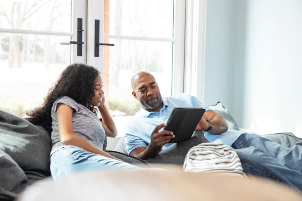 istock Dad helps teen daughter access site on tablet 2130908236
