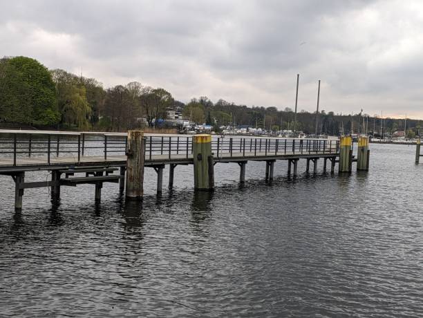 istock Metal bridge with yellow and green pillars on the river 2130908767