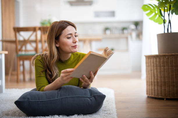 istock Young woman reading book 2130911890
