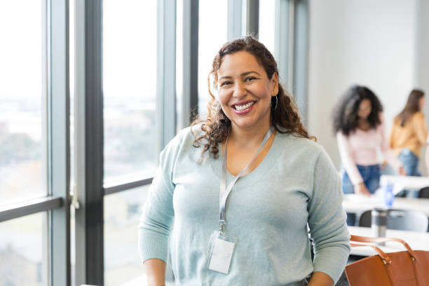 istock Female teacher smiles for camera after class 2130928504