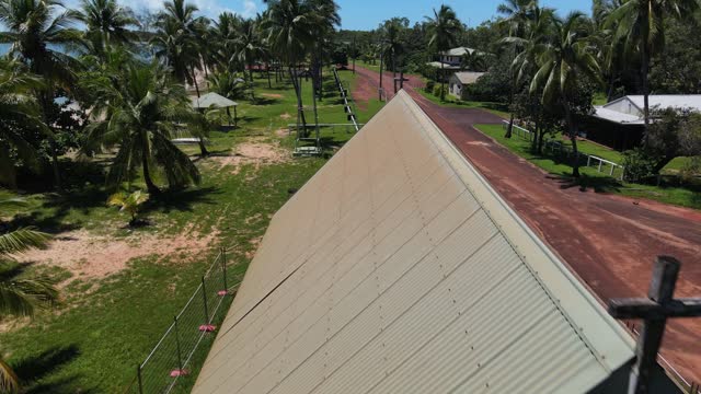 Aerial rearward clip of abandoned church in remote tropical Australia.
