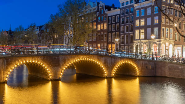 Night view of an old bridge crossing the Keizersgracht canal in Amsterdam, Netherlands stock photo